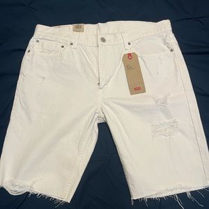 Men’s white distressed denim shorts, never worn tags still on.